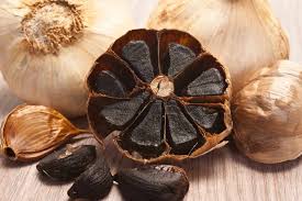 Peeled Black Garlic by dates and roots